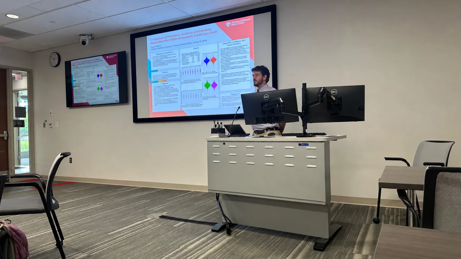 A student presents a research poster at the White Coats Write Code symposium