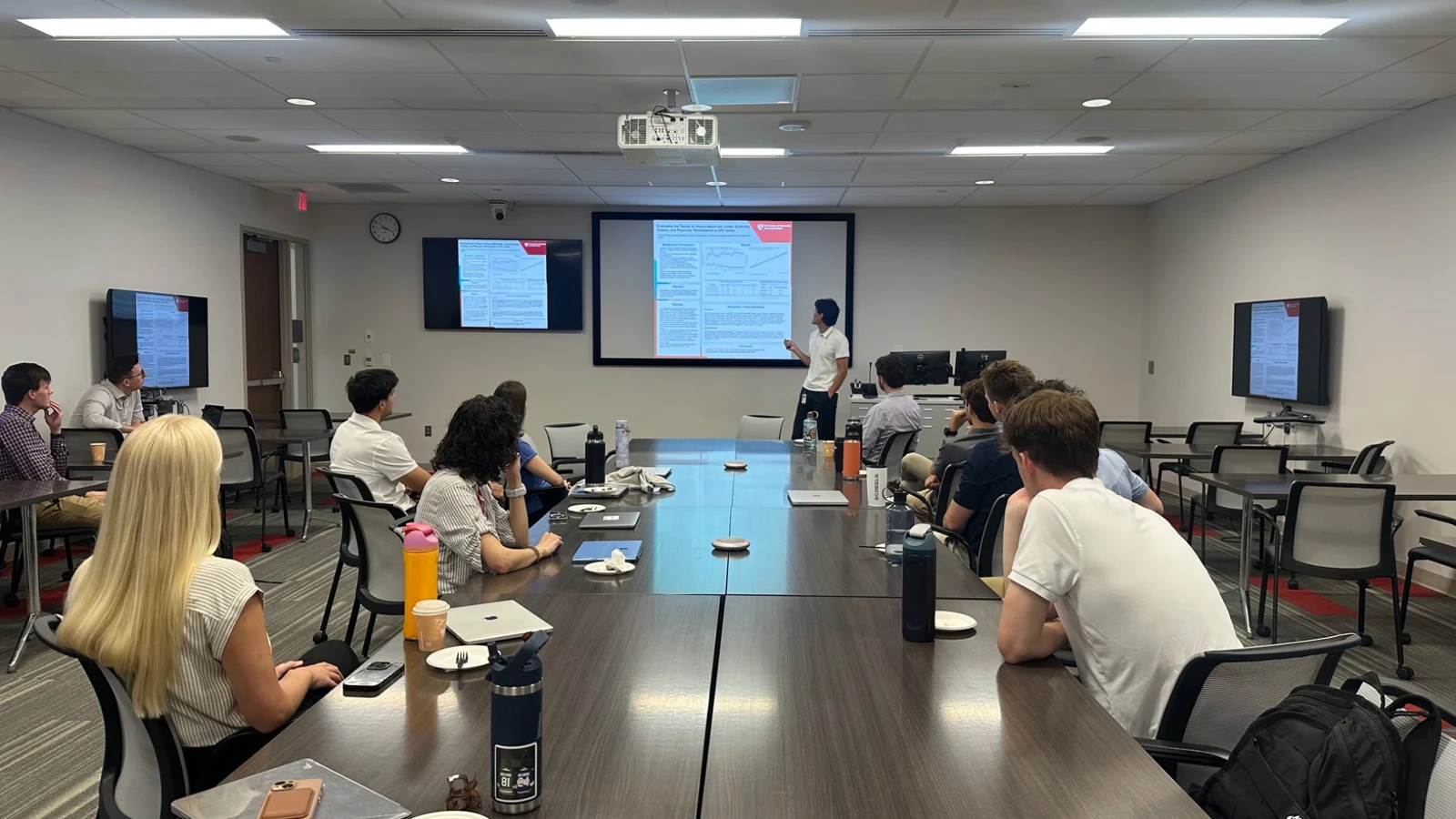 Students attending a research poster presentation at the White Coats Write Code symposium